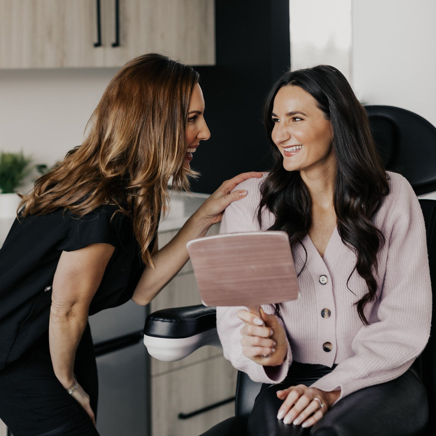 A patient smiling with a provider at MK Aesthetics in Minnetonka