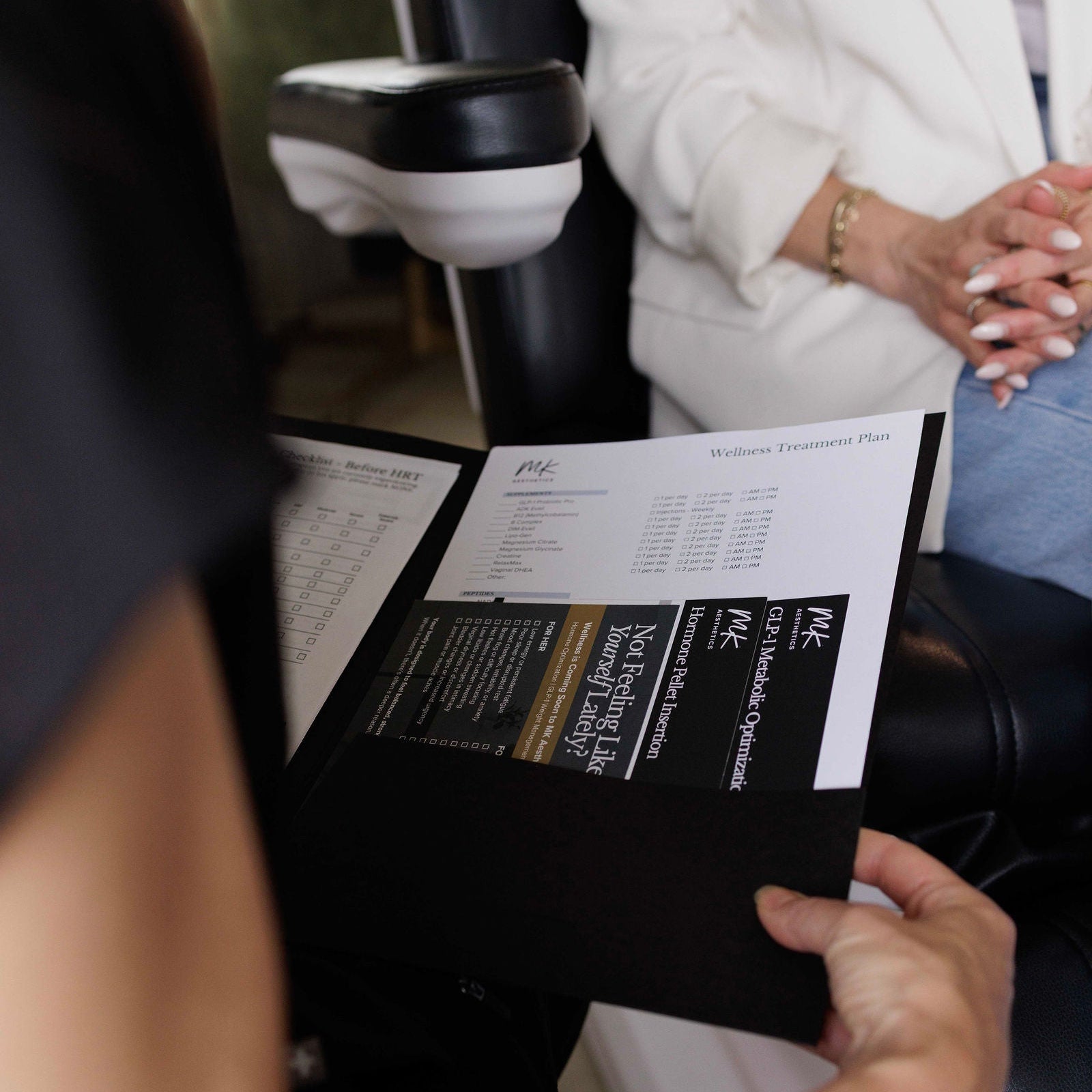 A provider reviewing a wellness treatment plan with a patient at MK Aesthetics