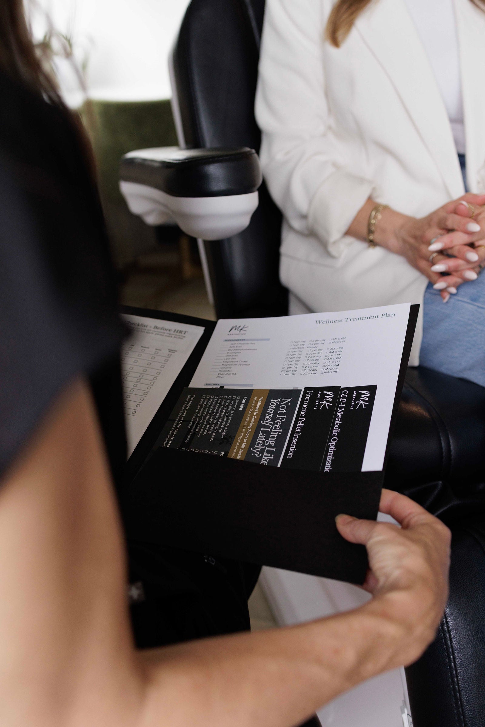A provider reviewing a wellness treatment plan with a patient at MK Aesthetics