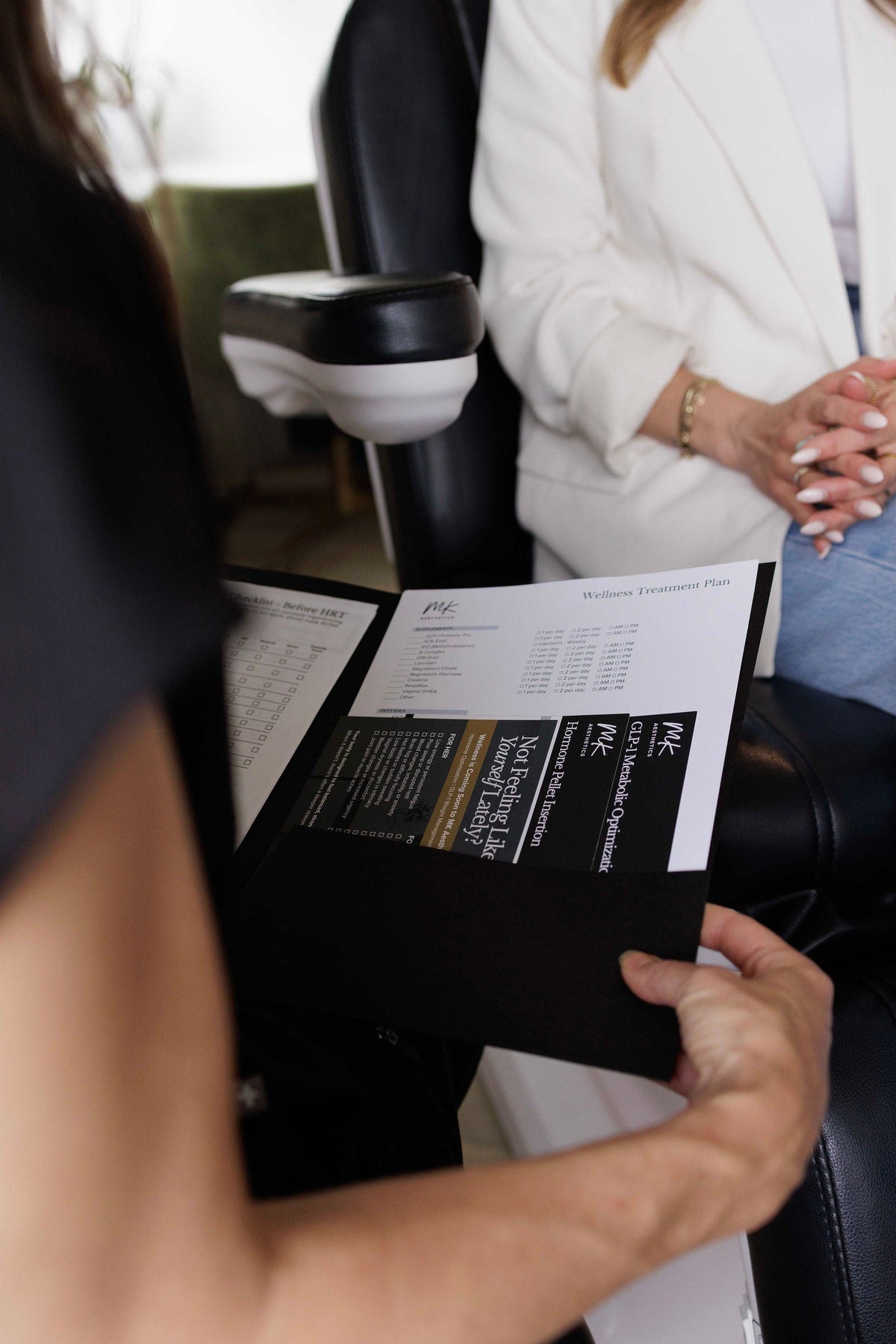 A provider reviewing a wellness treatment plan with a patient at MK Aesthetics