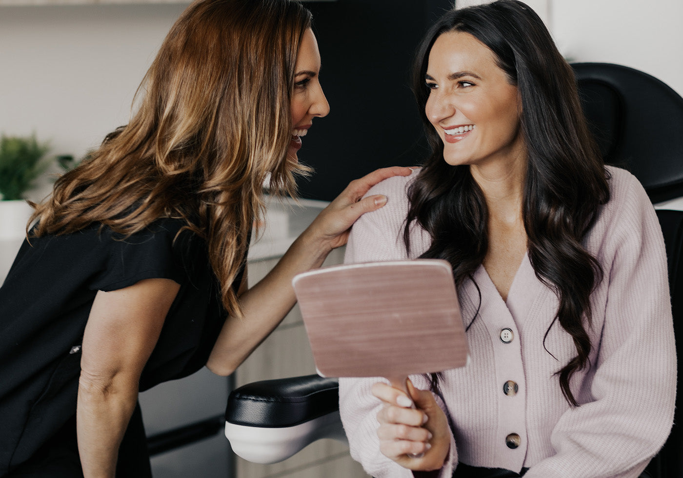 Client smiling while consulting with an aesthetician at MK Aesthetics in Minnetonka med spa.