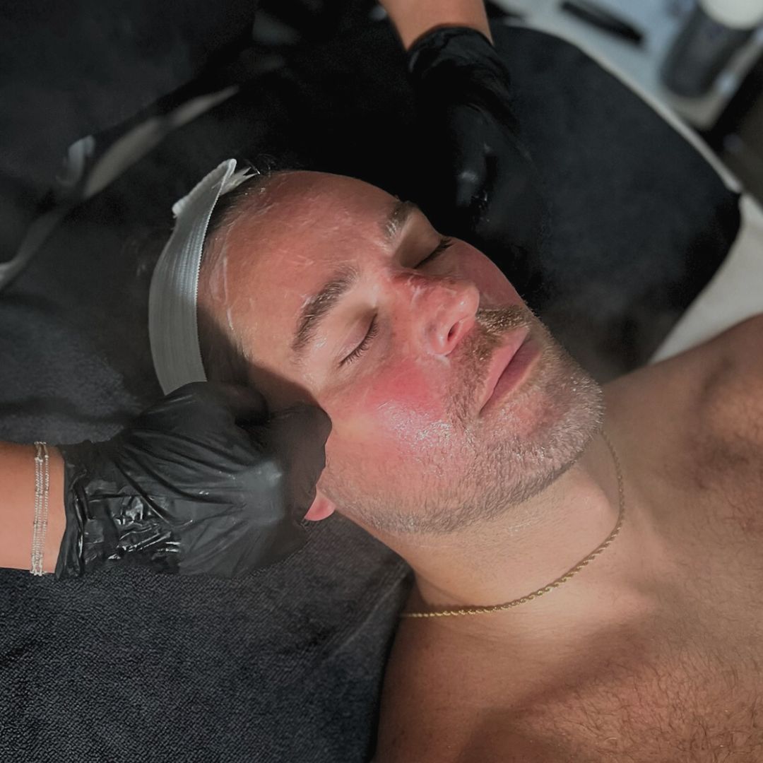 Man receiving a facial treatment at MK Aesthetics Med Spa in Minnetonka, enhancing skincare and relaxation.