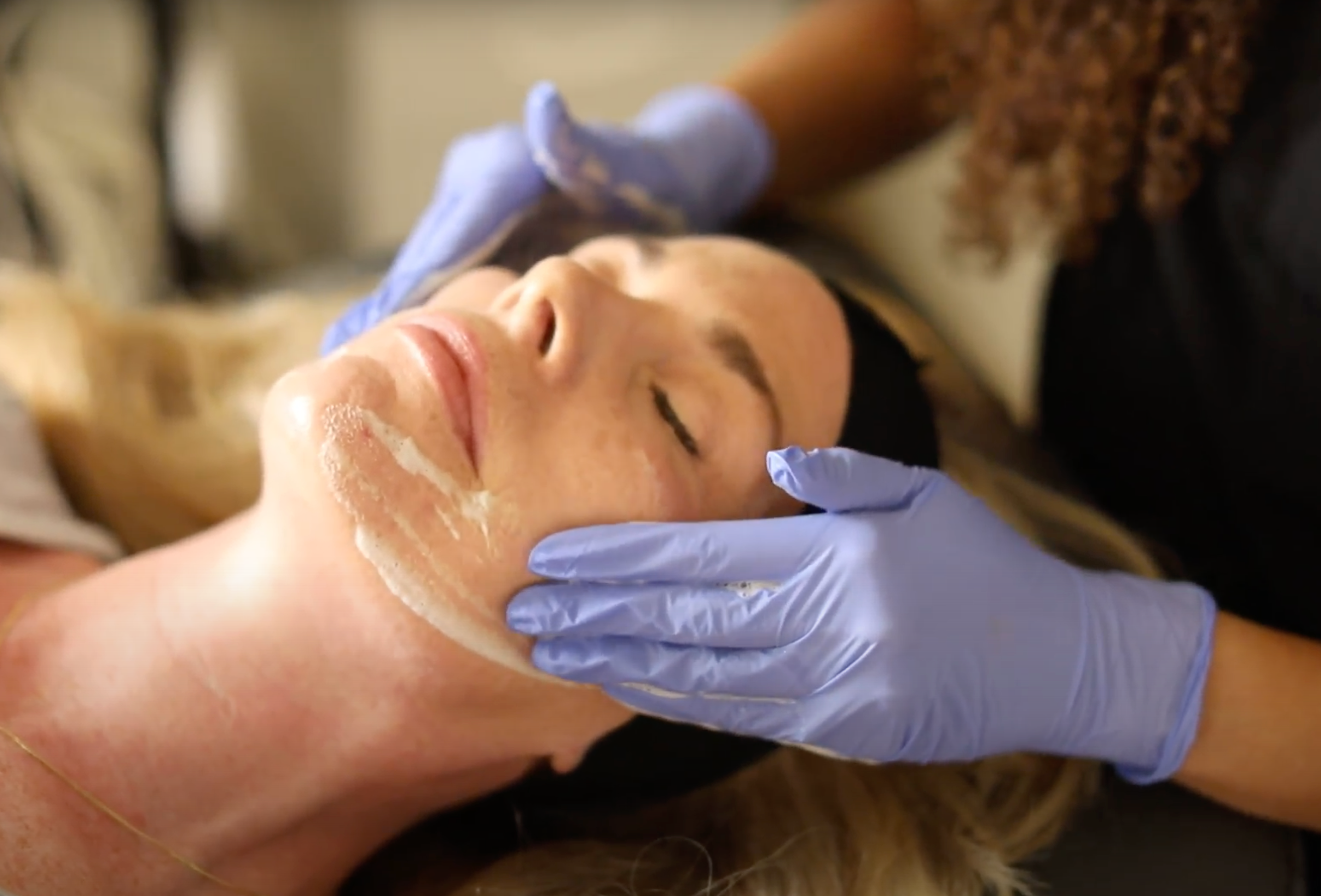 Client receiving a facial treatment at MK Aesthetics Med Spa in Minnetonka, showcasing skincare services.