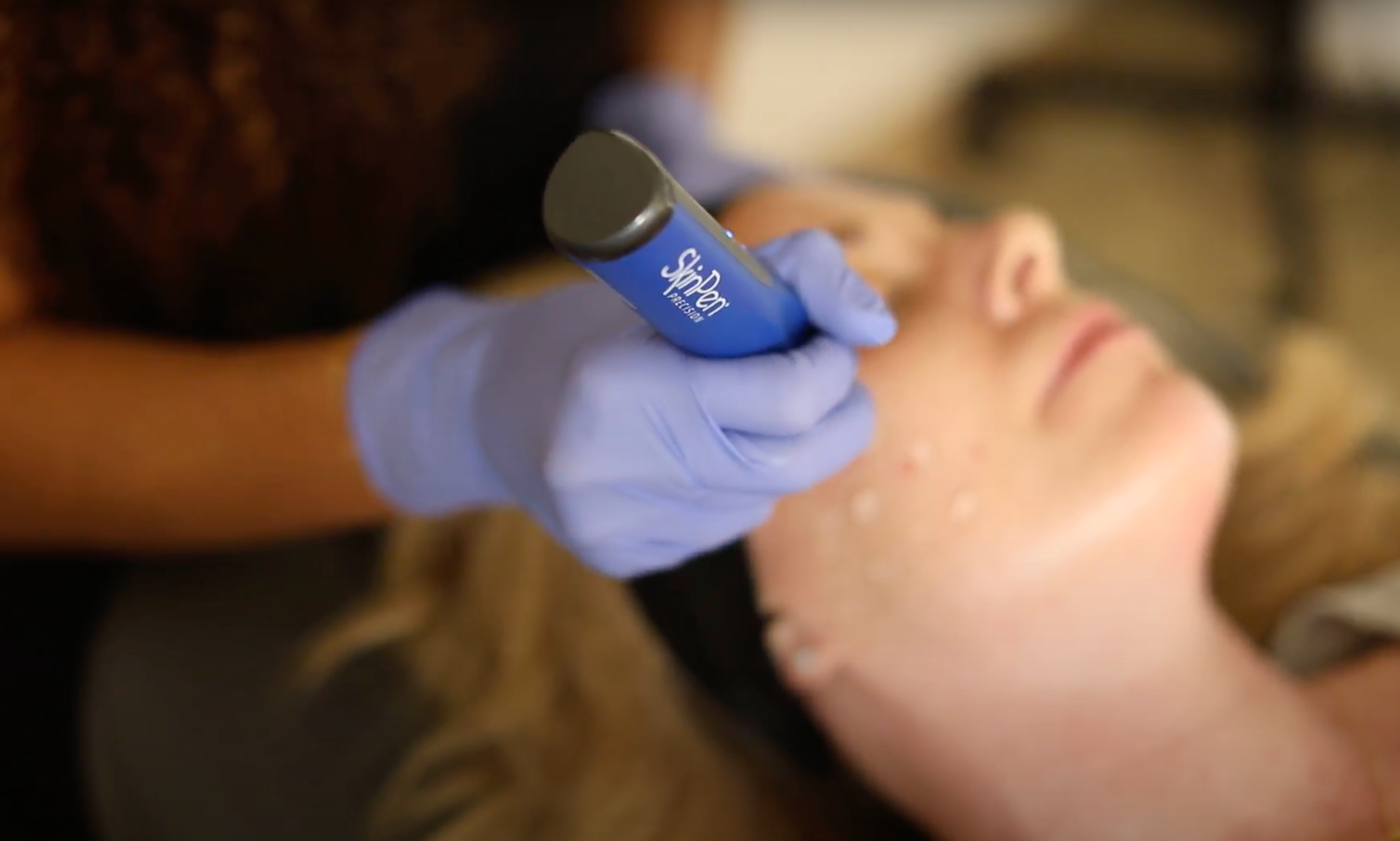 MK Aesthetics med spa treatment in Minnetonka, showcasing facial procedure with handheld device.