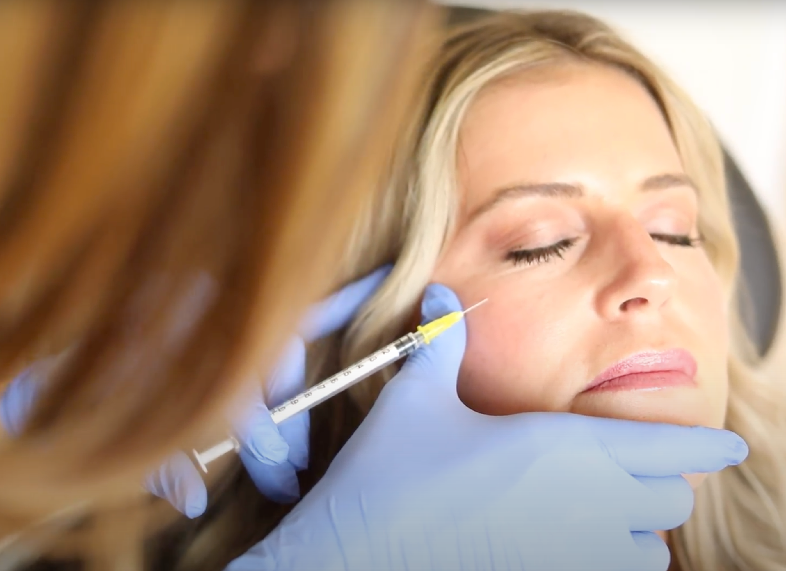 Client receiving aesthetic treatment at MK Aesthetics Med Spa in Minnetonka with skilled professional.