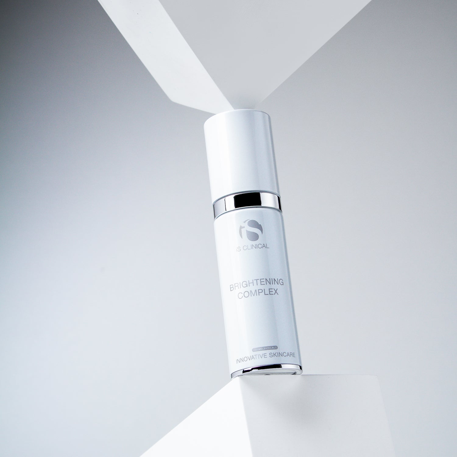 Brightening Complex serum by iS Clinical on a minimalist background, highlighting innovative skincare.