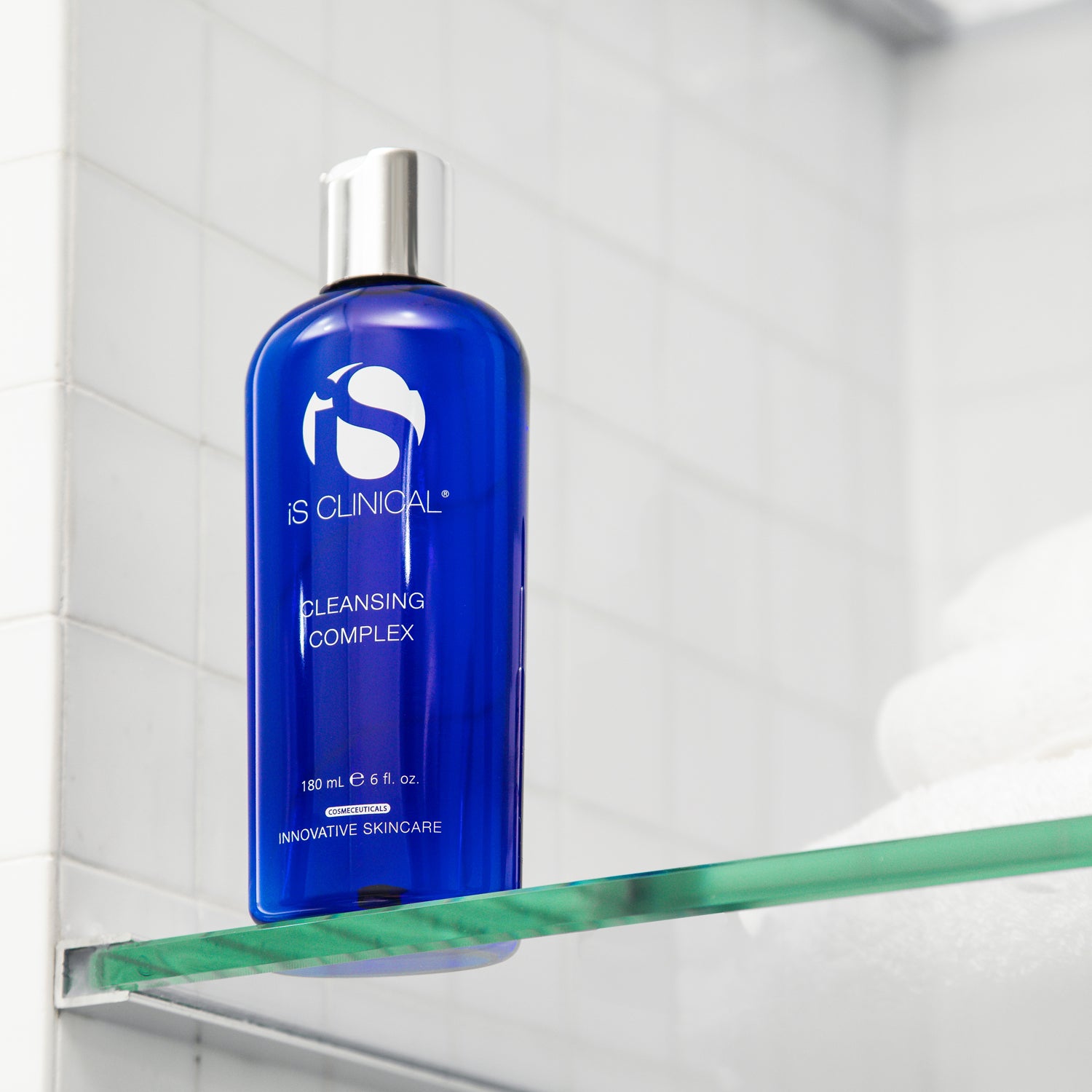 Cleansing Complex bottle by iS Clinical on a shelf at an aesthetics spa, ideal for all skin types.