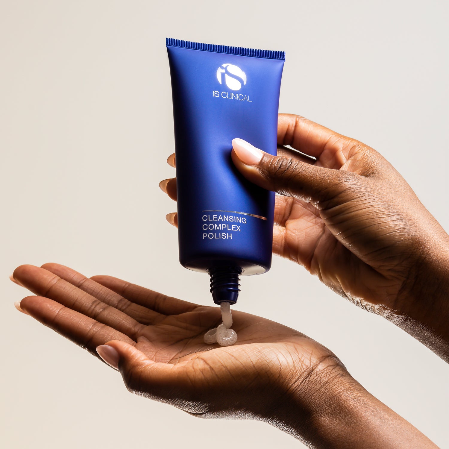 Cleansing Complex Polish bottle in hand, showcasing deep-cleansing and exfoliating properties for radiant skin.
