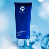 Cleansing Complex Polish tube by iS CLINICAL on a reflective surface with a blue background.