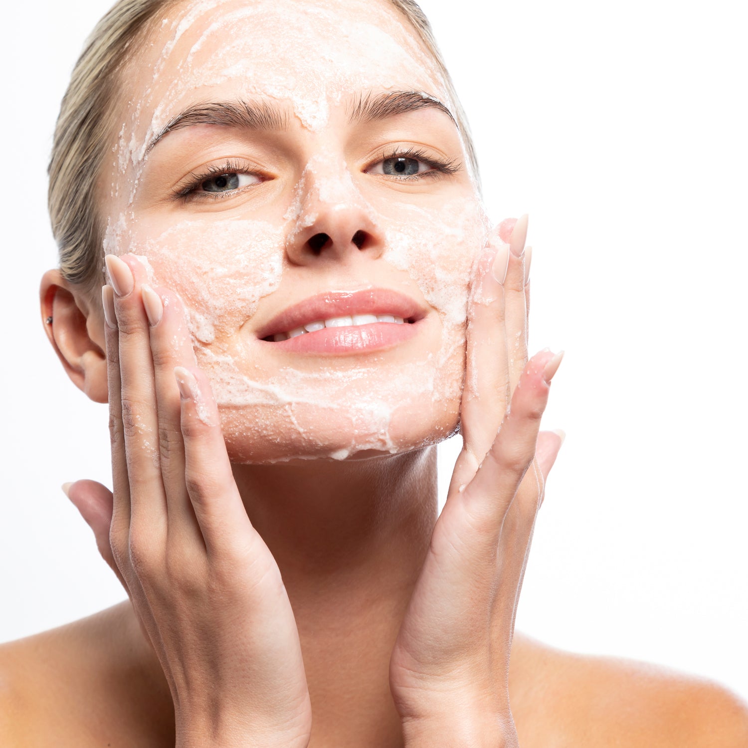 Woman applying Cleansing Complex Polish for deep cleansing and exfoliation at MK Aesthetics Spa.