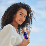 Copper Firming Mist model holding bottle outdoors, demonstrating skin hydration and firming benefits.