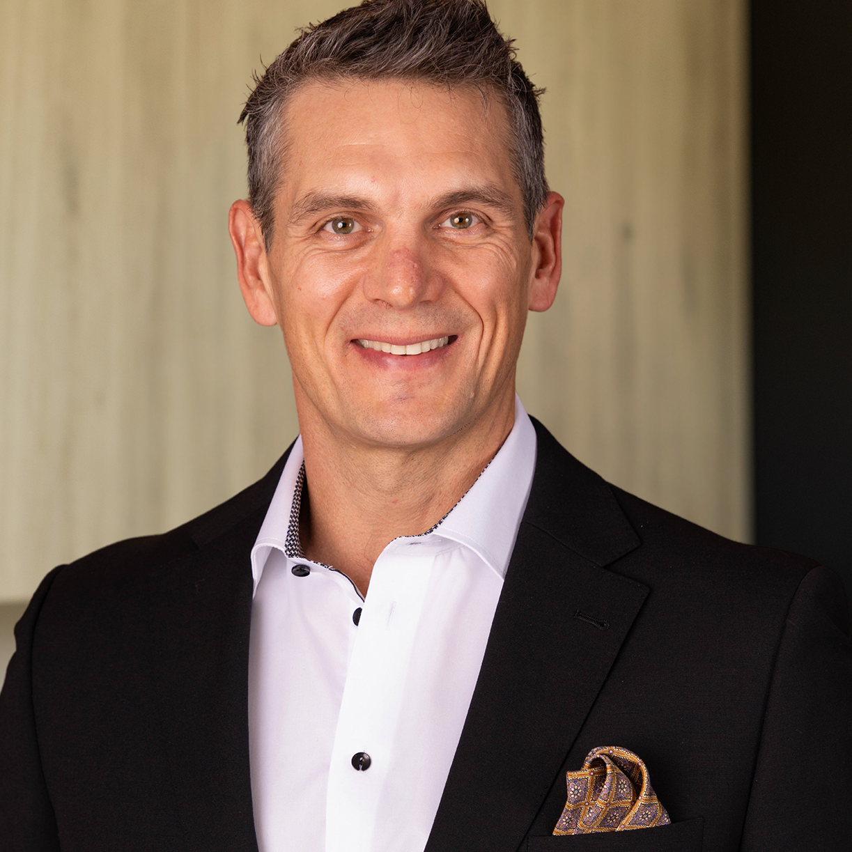 Professional portrait of a man in a suit, representing MK Aesthetics Med Spa in Minnetonka.