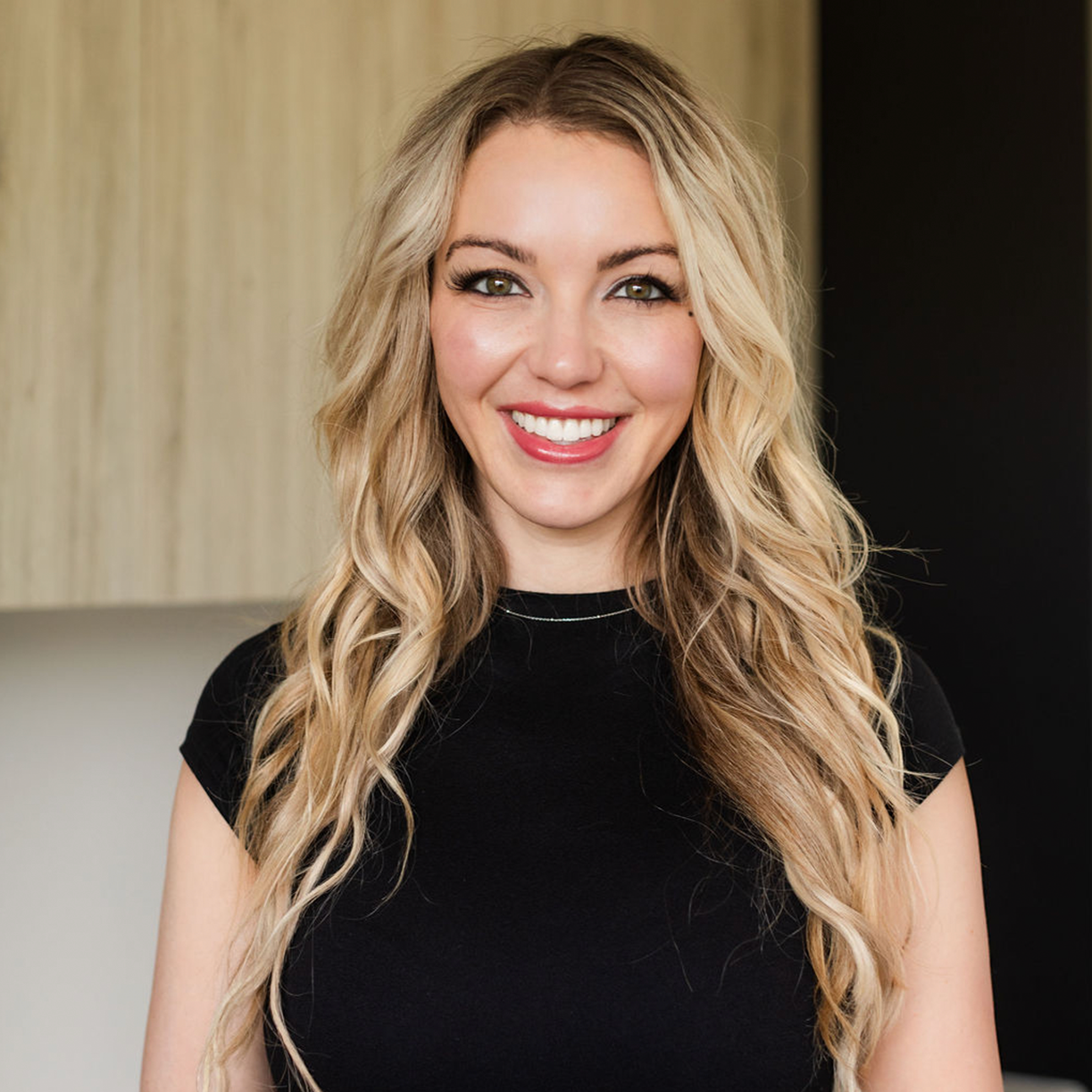 Professional at MK Aesthetics Minnetonka smiling in a modern med spa setting, showcasing expertise in aesthetic treatments.