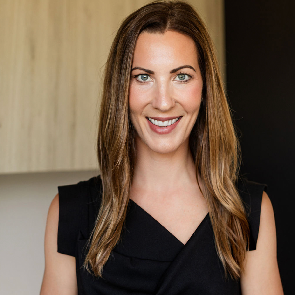 Professional portrait of a smiling woman at MK Aesthetics Minnetonka, representing a welcoming Med Spa environment.