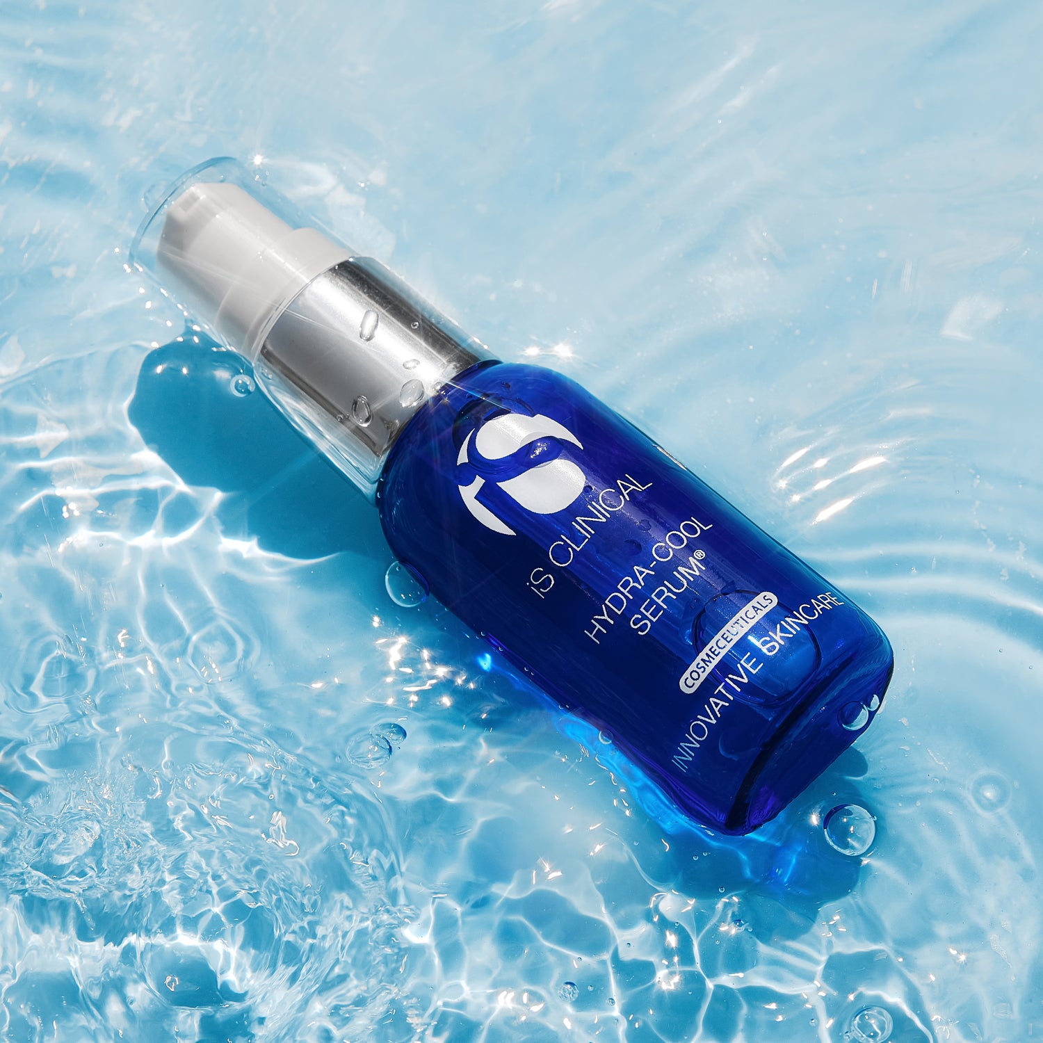 Hydra-Cool Serum by IS Clinical, a hydrating skincare product, floating in water. Perfect for all skin types.