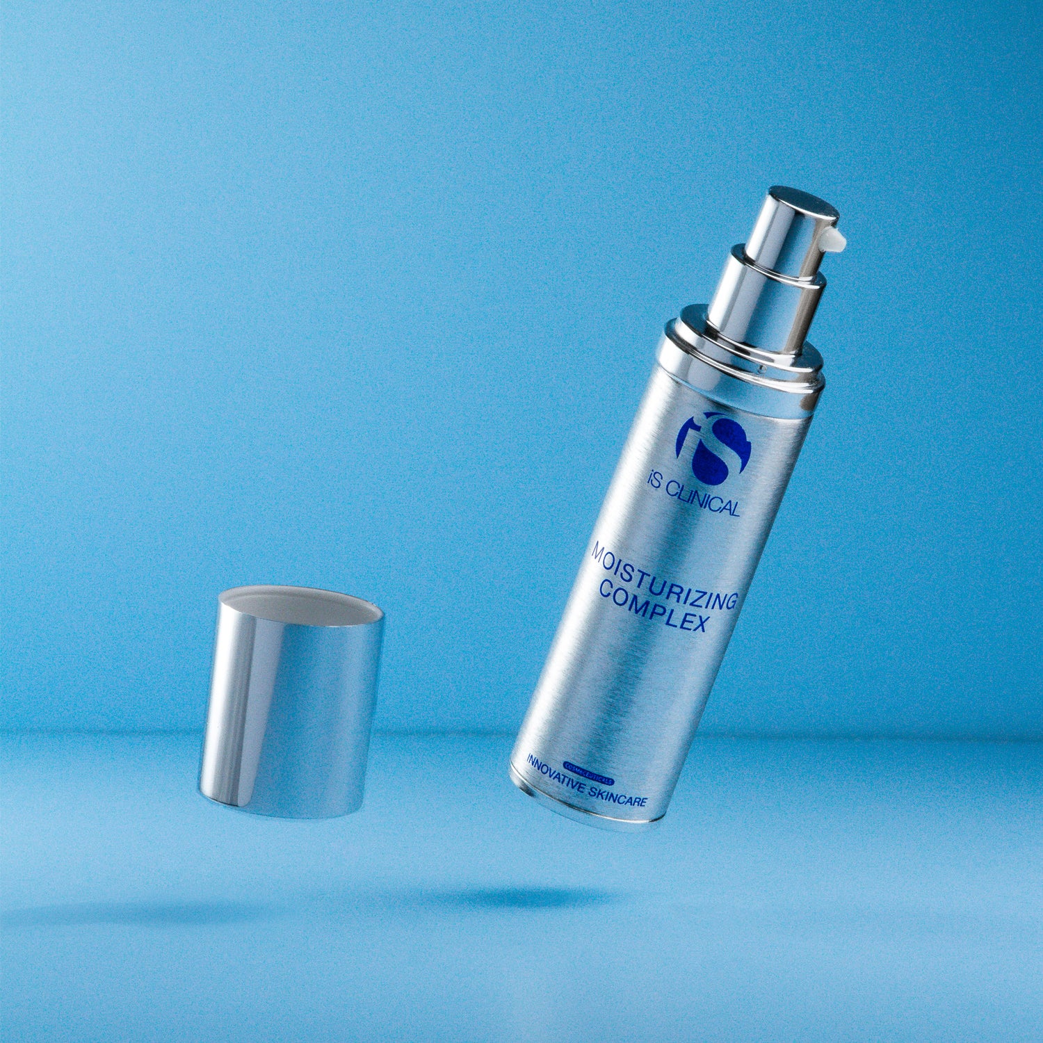 Moisturizing Complex bottle by IS Clinical on a blue background, featuring a sleek design for hydrating skincare.