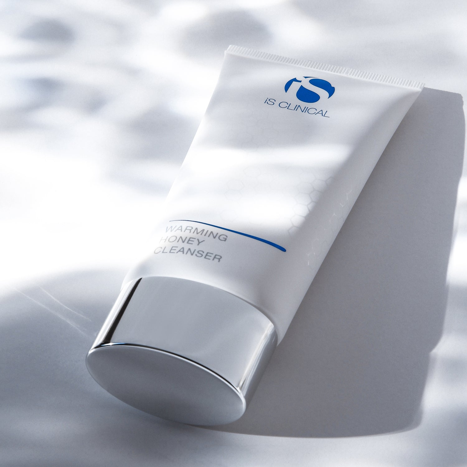 Warming Honey Cleanser tube from IS CLINICAL, ideal for deep cleansing and nourishing skincare.