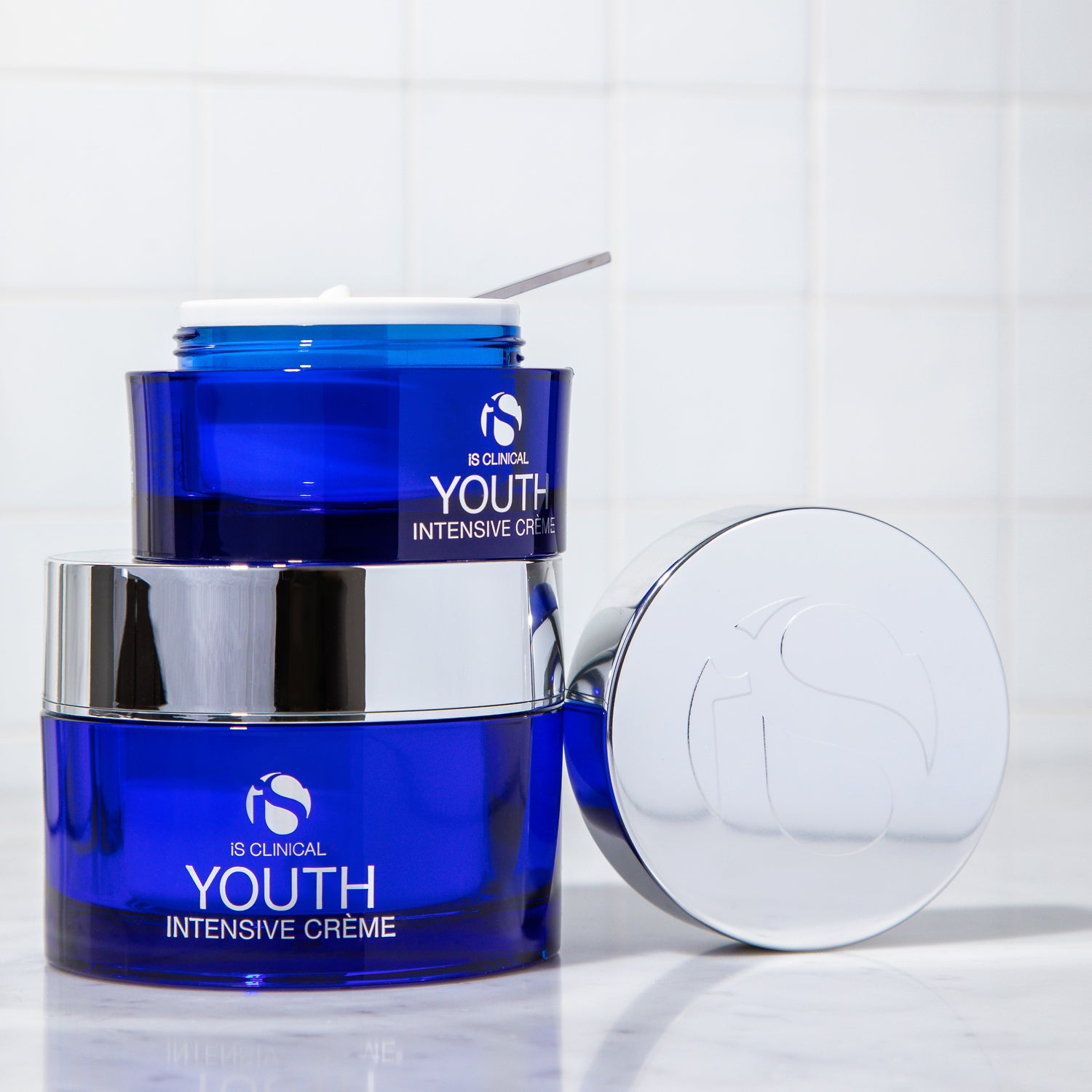 Youth Intensive Crème 1.7oz in blue jars for age-defying hydration and skin firmness by MK Aesthetics.